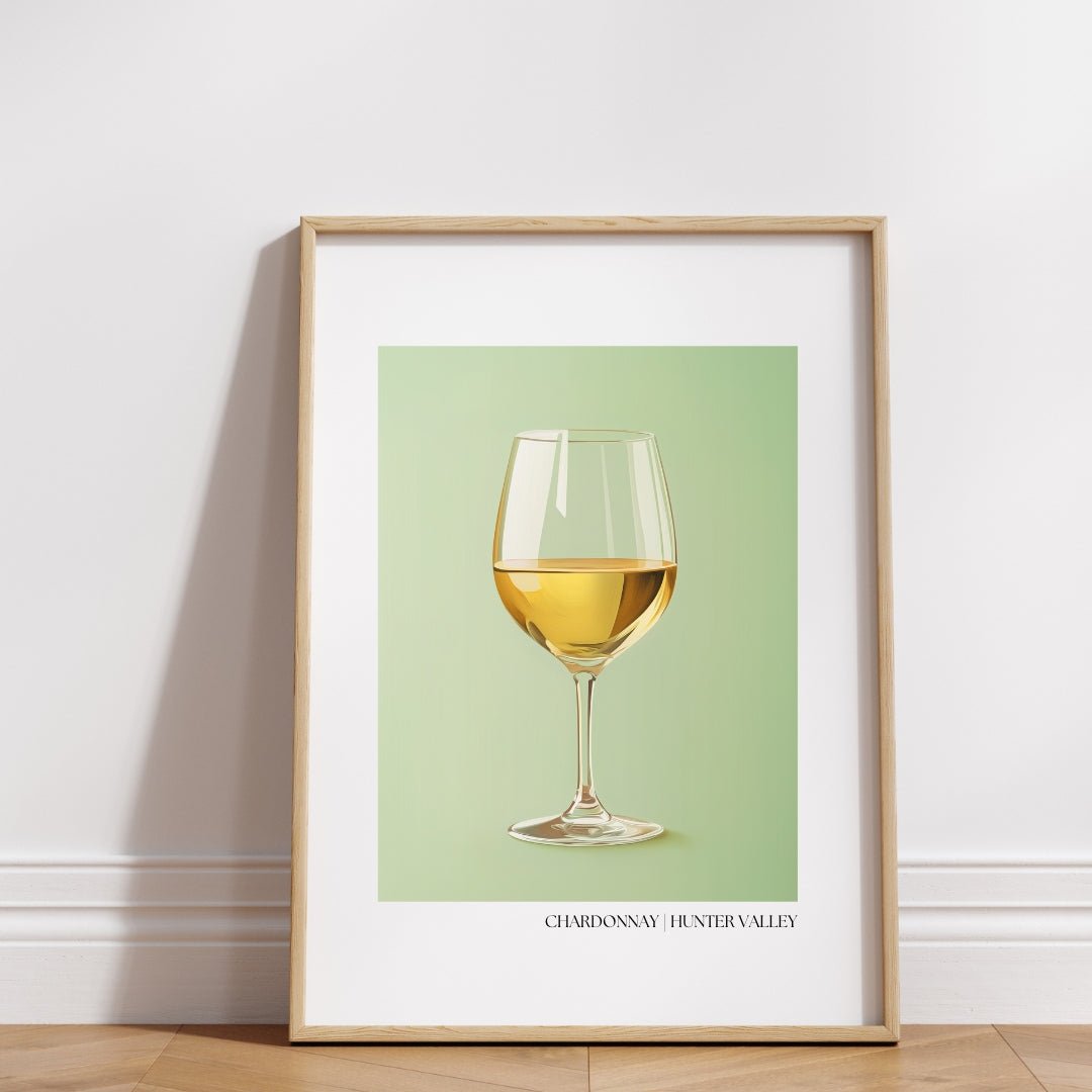 A framed A3 poster featuring a minimalist illustration of a glass of golden Chardonnay wine set against a soft sage green background. The artwork is elegantly displayed in a light wooden frame, leaning against a white wall on a wooden floor. Below the image, the text "CHARDONNAY | HUNTER VALLEY" is printed in refined typography, highlighting the wine’s origin. This stylish and sophisticated presentation makes the poster ideal for home décor or as a luxurious souvenir celebrating the Hunter Valley wine regio