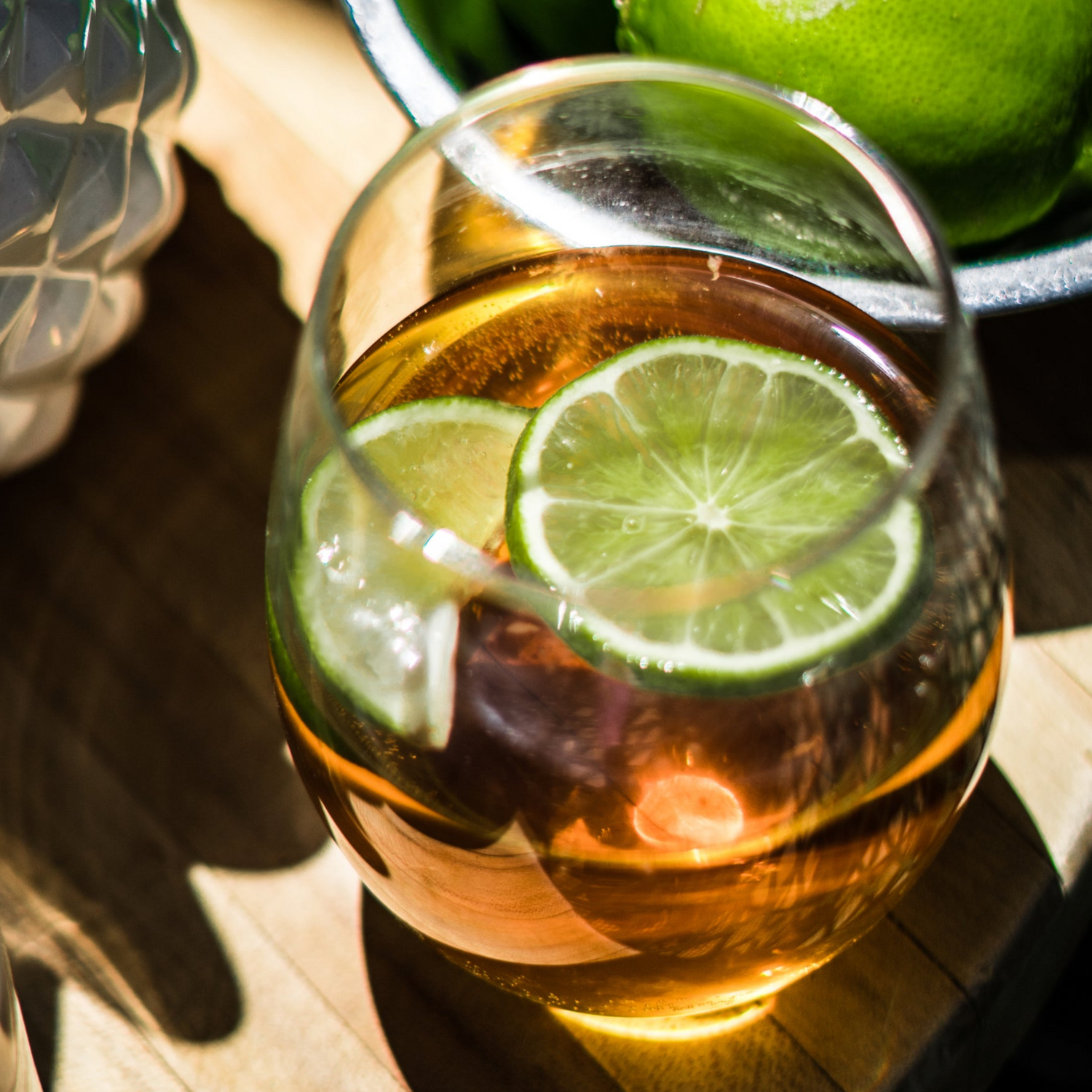 Glass of a sophisticated non-alcoholic drink garnished with lime slices, highlighting Stay n’ Sip’s inclusive tasting options for mindful drinkers, minors, and pregnant guests during wine tasting experiences