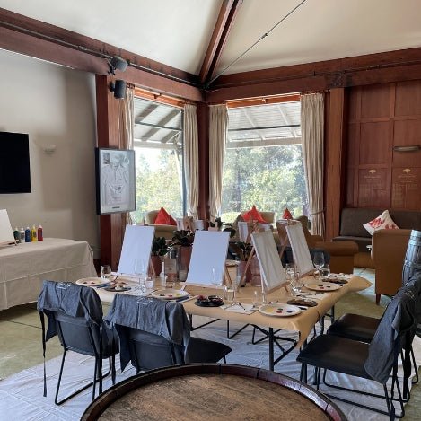 Small table set for a paint lesson and wine tasting class.