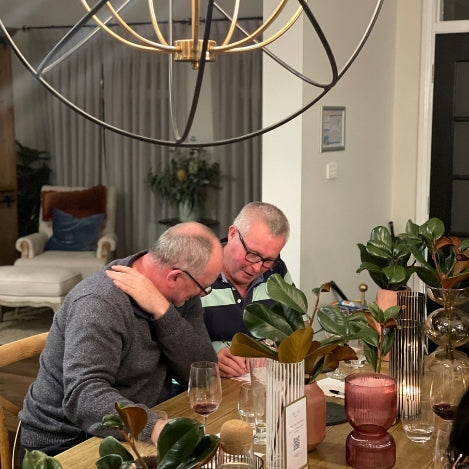 Two guests conferring over answers to wine related games.